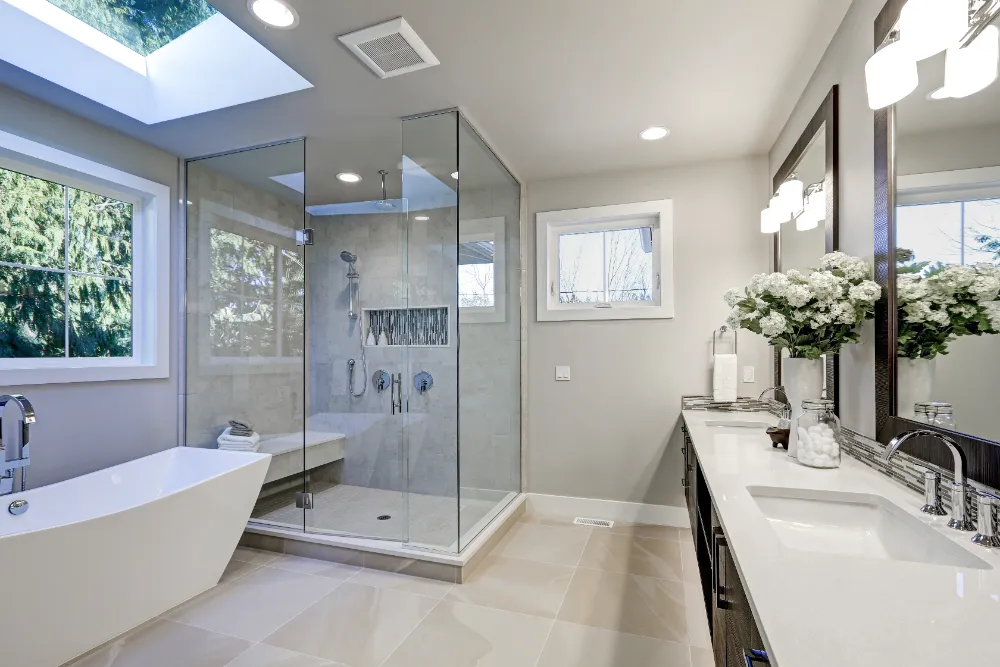Modern bathroom remodel featuring a glass shower, freestanding tub, and double vanity—capturing Restorations Unlimited’s thoughtful design and precision craftsmanship in Maine bathroom renovations.