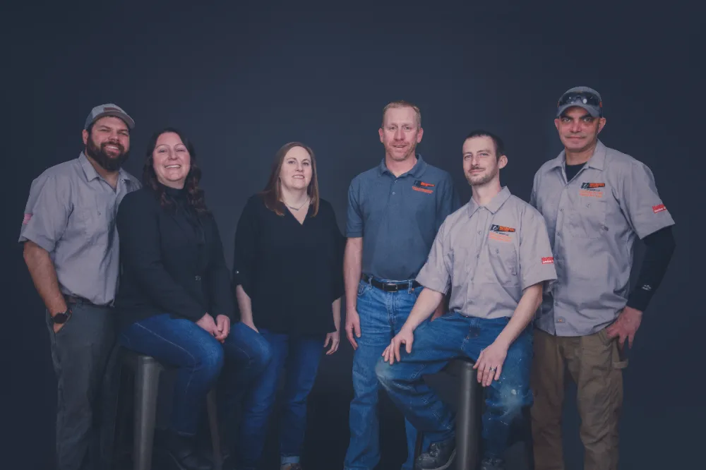The Restorations Unlimited team posing together in the studio, representing their trusted general contracting services across Maine from Winterport to Bar Harbor