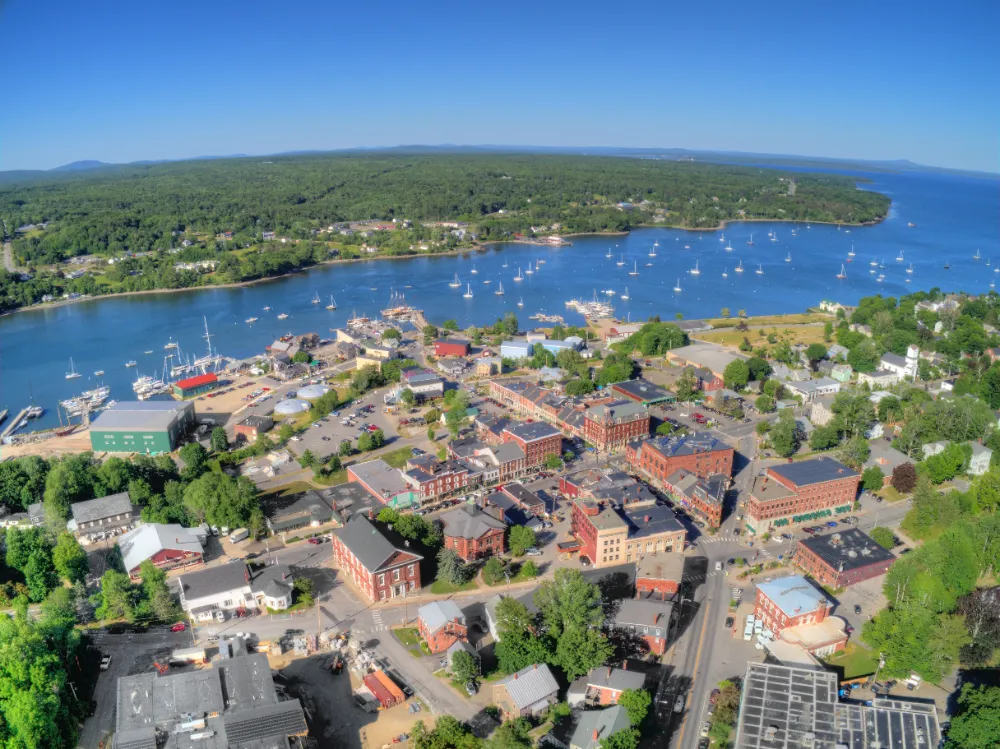Aerial view of Belfast, Maine’s coastal downtown and harbor, representing Restorations Unlimited’s kitchen remodeling services in Belfast