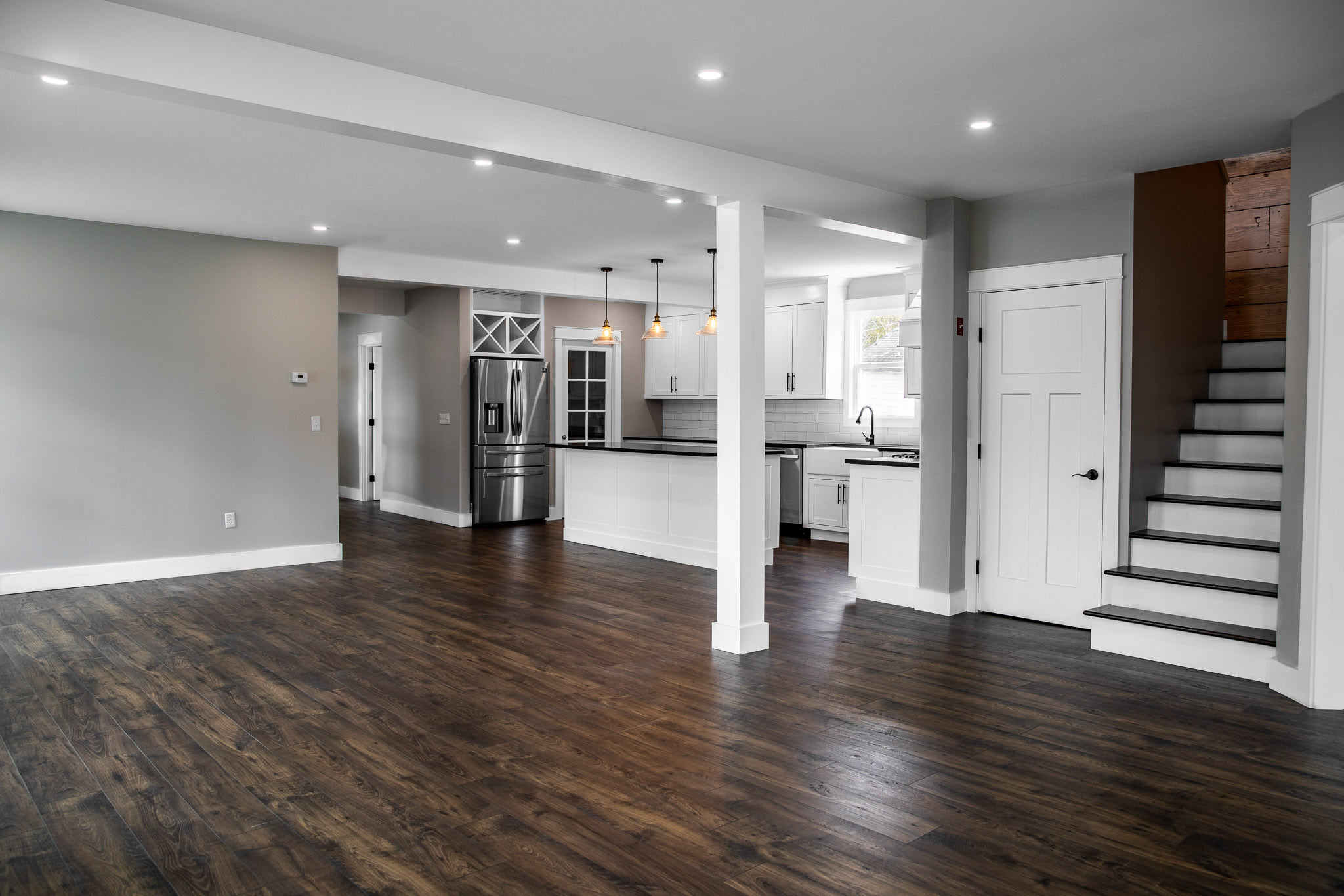 Newly renovated open-concept living area and kitchen with hardwood floors in Hermon, Maine, representing Restorations Unlimited’s home renovation services