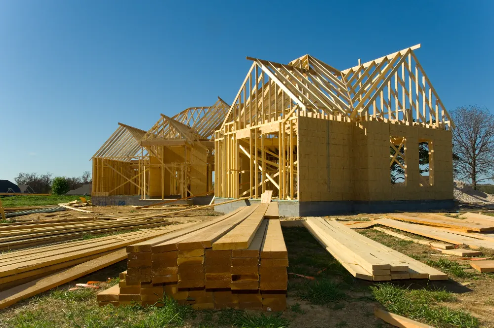 Wood-framed home under construction under a clear blue Maine sky—representing Restorations Unlimited’s trusted, organized, and detail-driven new construction process for builders, owners, and developers.